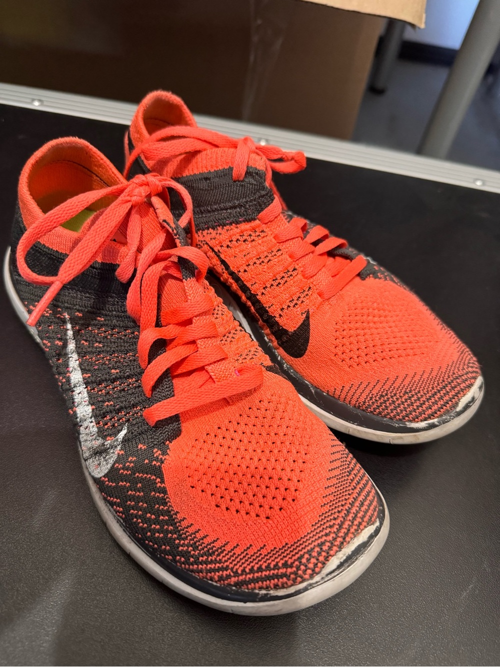 Nike Flyknit Low-Profile Running Shoes in Bright Coral and Black/gray